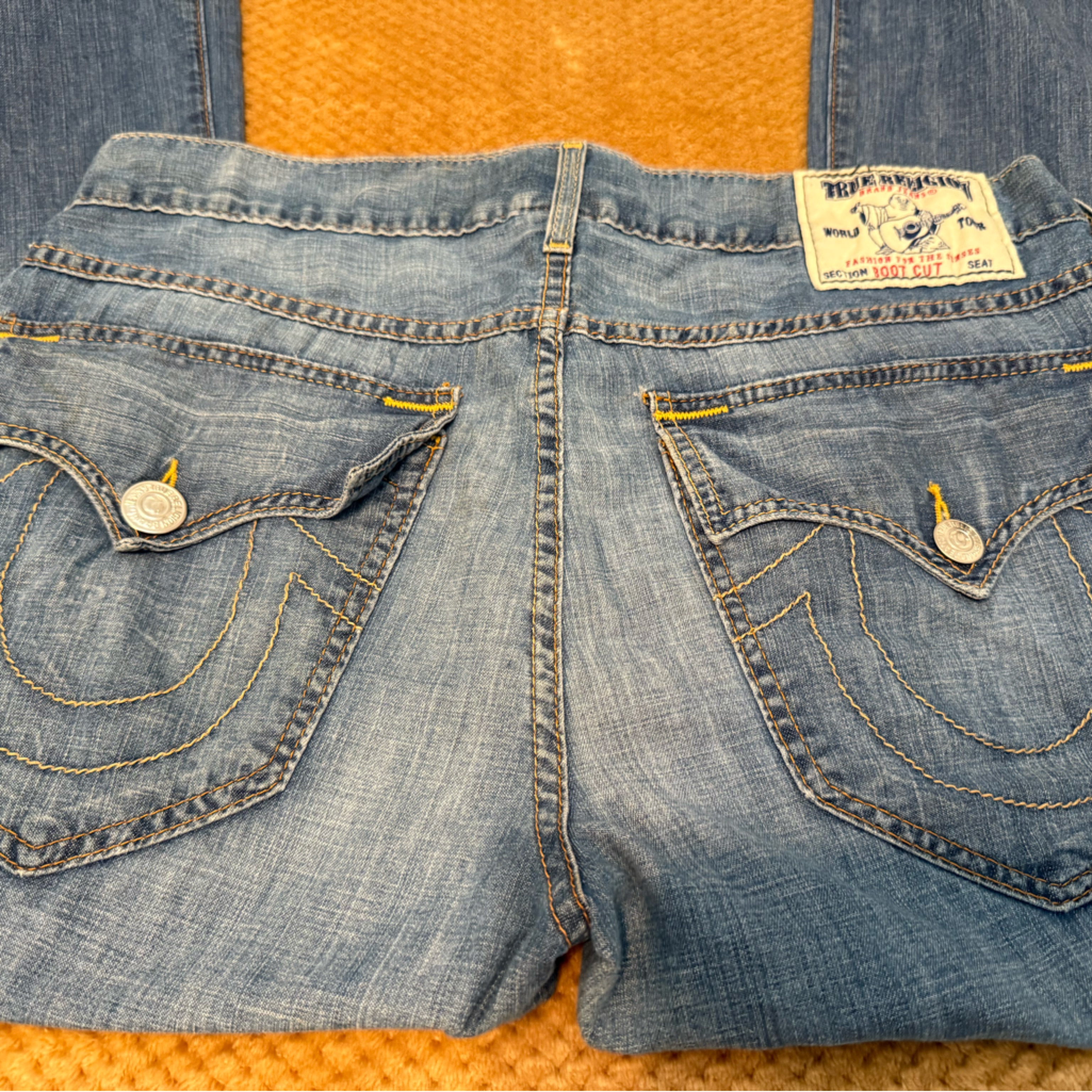 True Religion Blue Jeans With Distressed Details And Fading